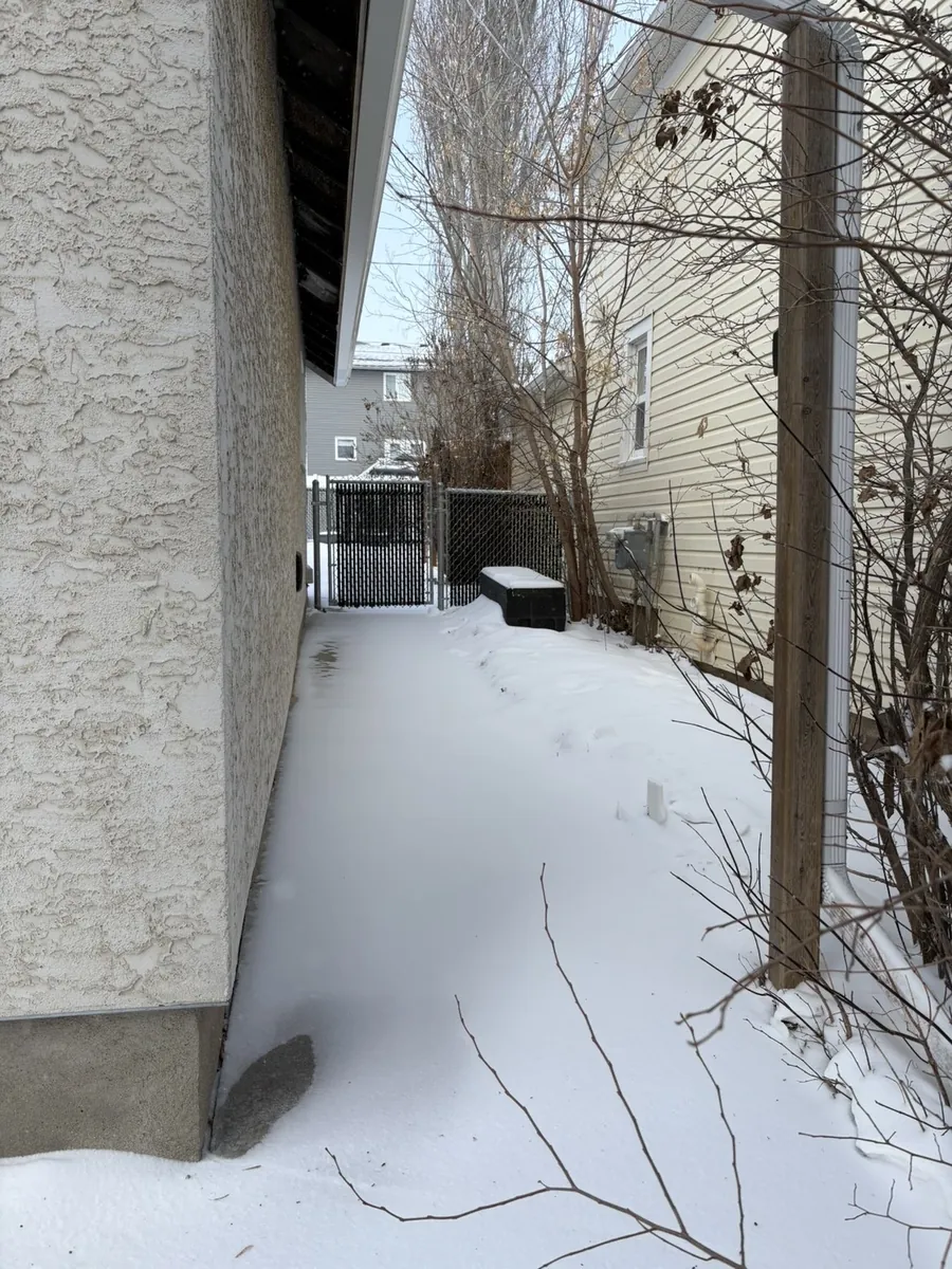Snowy side pathway before snow removal in Moose Jaw Saskatchewan