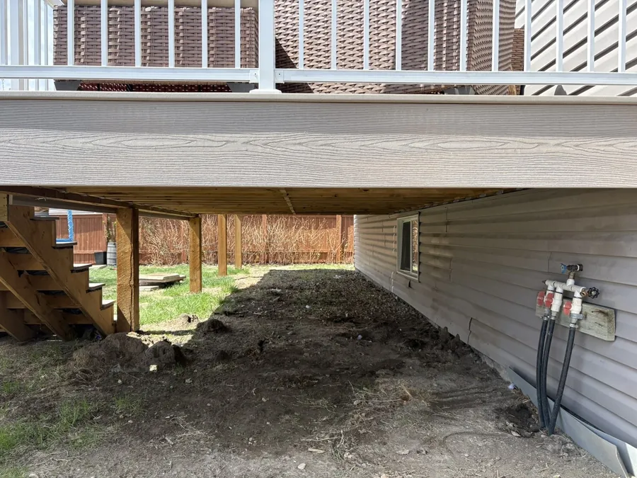 Bare dirt under a deck before gravel installation in Moose Jaw Saskatchewan